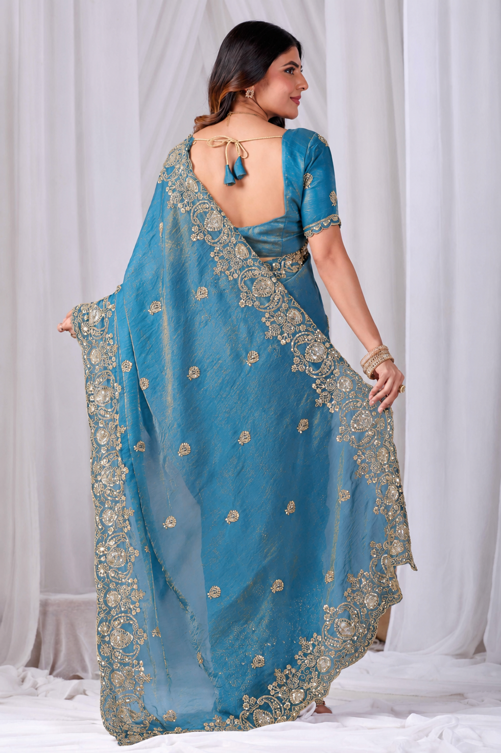 Azure Blue Tikki Moti Work Embroidered Designer Saree Azure Blue Tikki Moti Work Embroidered Designer Saree + The Azure Blue Tikki Moti Work Embroidered Designer Saree brings tikki (metallic sequin) and moti (pearl-bead) hand embroidery to a azure blue base, and it's built for anyone comparing options for an azure blue saree rather than something purely decorative. The colour reads true in both daylight and indoor event lighting, which matters more than it sounds &mdash; a lot of sarees photograph differently under venue lighting than they do in a product shot, and this one has been chosen to hold its tone consistently. &bull; Craftsmanship