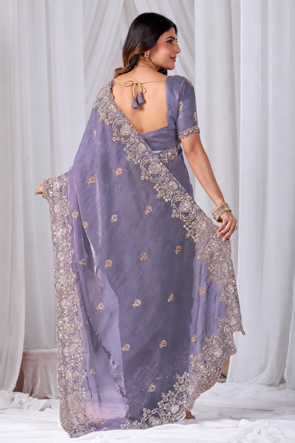 Purple Tikki Moti Work Embroidered Designer Saree Purple Tikki Moti Work Embroidered Designer Saree + The Purple Tikki Moti Work Embroidered Designer Saree brings tikki (metallic sequin) and moti (pearl-bead) hand embroidery to a purple base, and it's built for anyone comparing options for a purple saree rather than something purely decorative. The colour reads true in both daylight and indoor event lighting, which matters more than it sounds &mdash; a lot of sarees photograph differently under venue lighting than they do in a product shot, and this one has been chosen to hold its tone consistently. &bull; Craftsmanship
