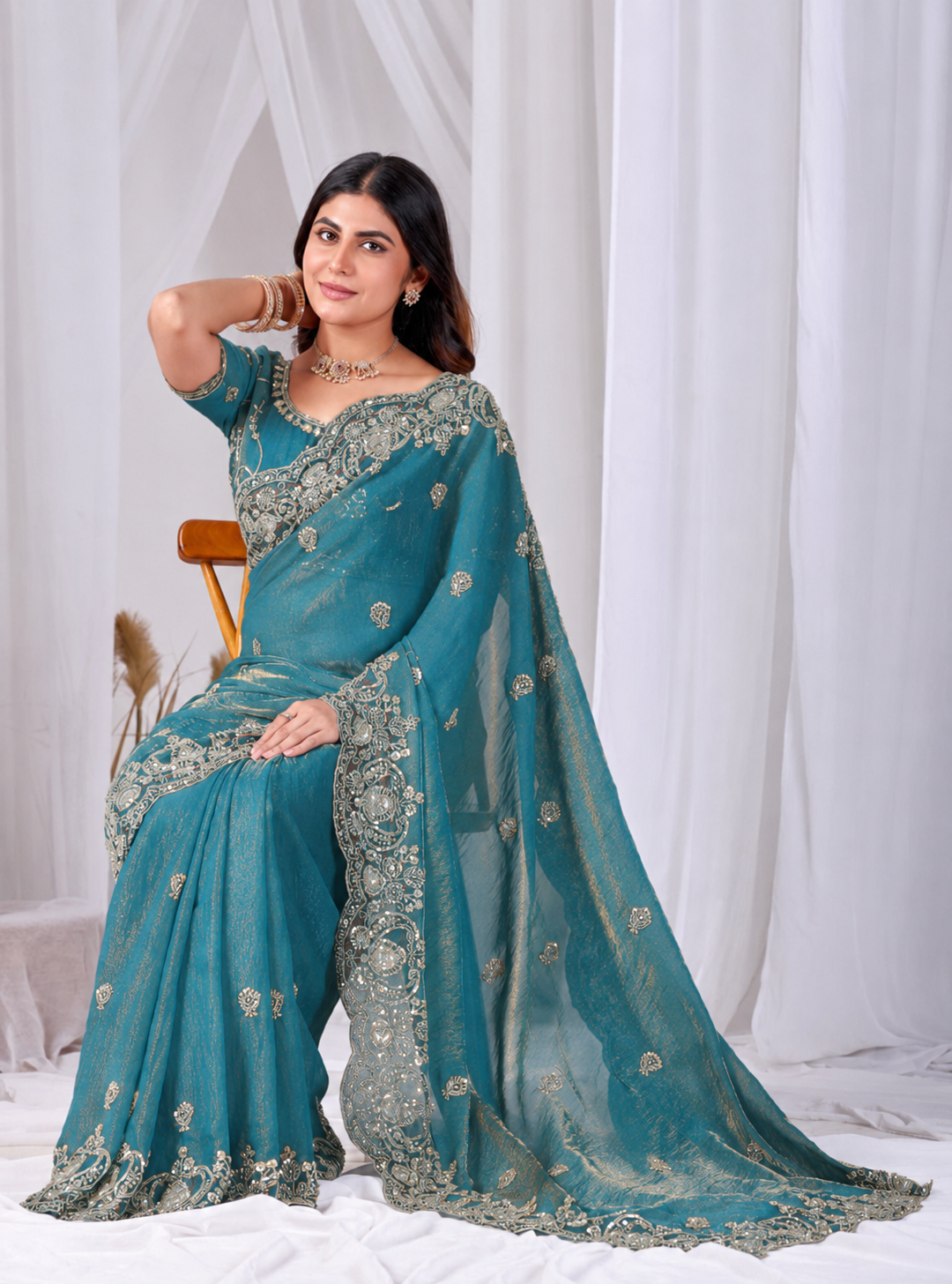Teal Blue Tikki Moti Work Embroidered Designer Saree Teal Blue Tikki Moti Work Embroidered Designer Saree + The Teal Blue Tikki Moti Work Embroidered Designer Saree brings tikki (metallic sequin) and moti (pearl-bead) hand embroidery to a teal blue base, and it's built for anyone comparing options for a teal color saree rather than something purely decorative. The colour reads true in both daylight and indoor event lighting, which matters more than it sounds &mdash; a lot of sarees photograph differently under venue lighting than they do in a product shot, and this one has been chosen to hold its tone consistently. &bull; Craftsmanship