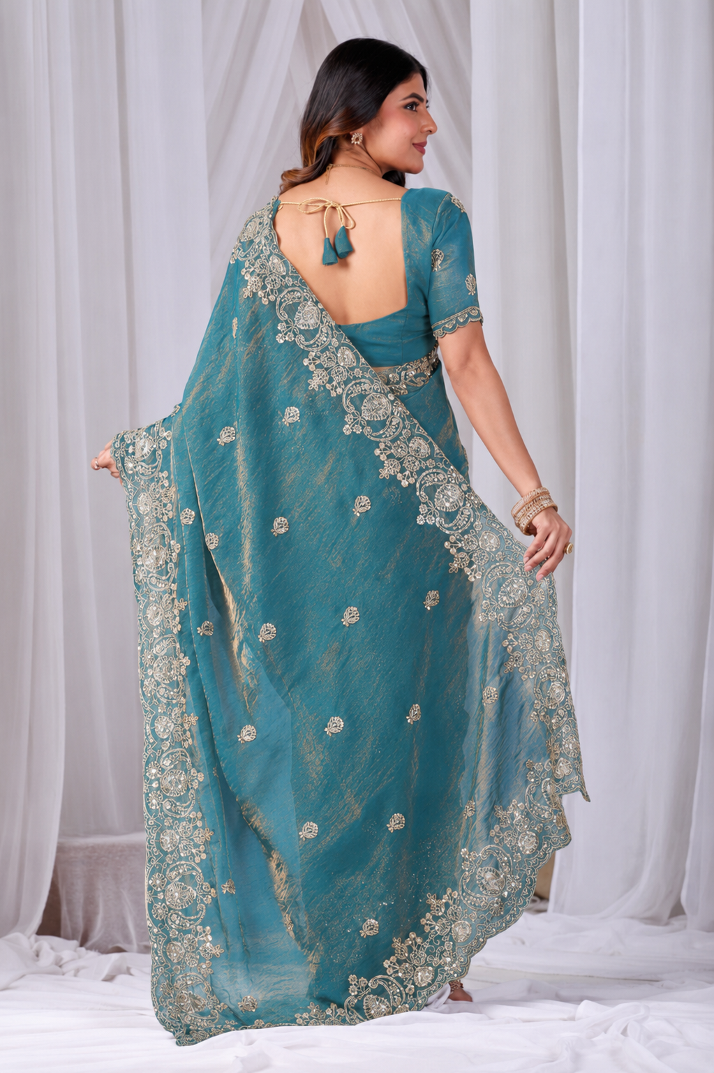 Teal Blue Tikki Moti Work Embroidered Designer Saree Teal Blue Tikki Moti Work Embroidered Designer Saree + The Teal Blue Tikki Moti Work Embroidered Designer Saree brings tikki (metallic sequin) and moti (pearl-bead) hand embroidery to a teal blue base, and it's built for anyone comparing options for a teal color saree rather than something purely decorative. The colour reads true in both daylight and indoor event lighting, which matters more than it sounds &mdash; a lot of sarees photograph differently under venue lighting than they do in a product shot, and this one has been chosen to hold its tone consistently. &bull; Craftsmanship